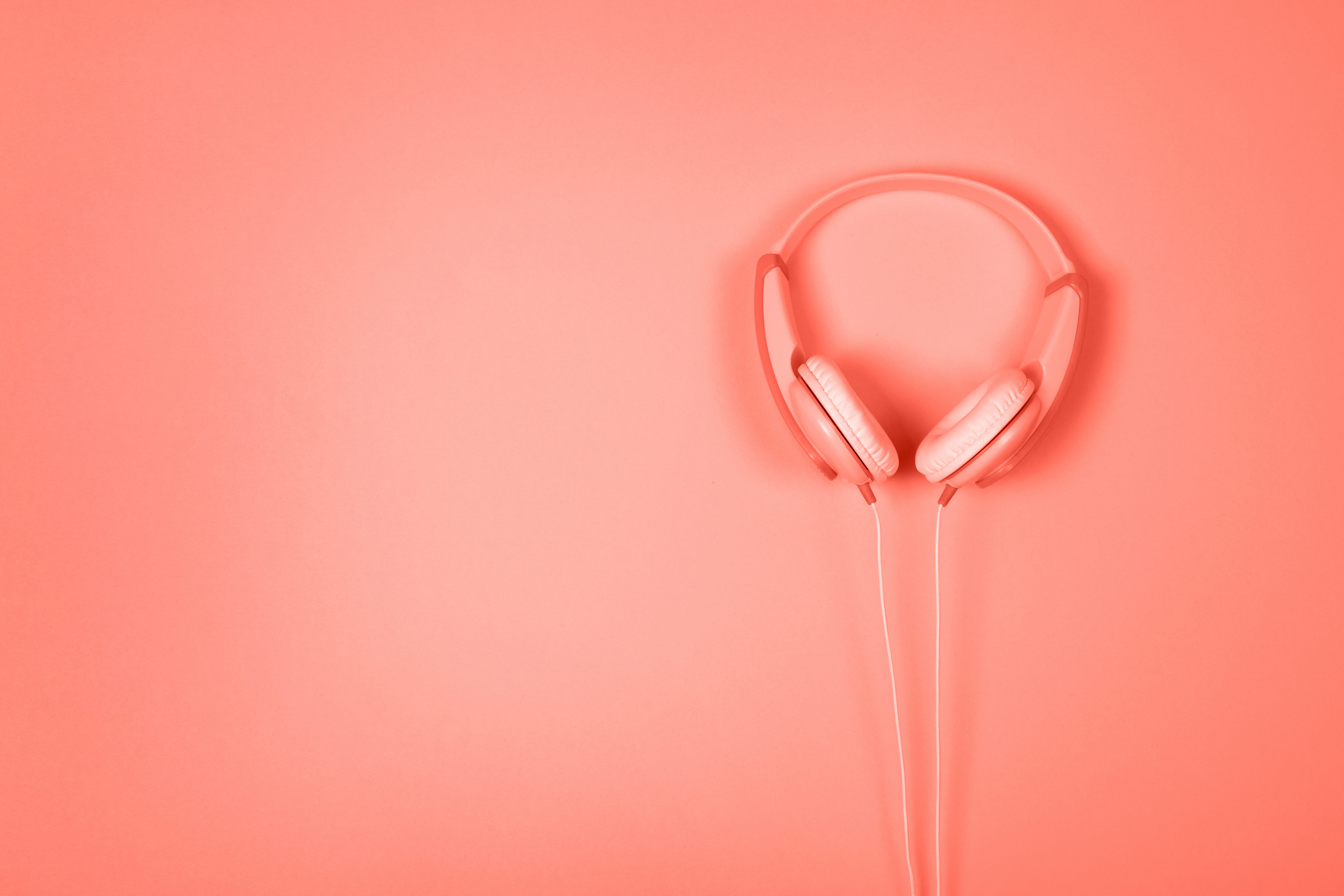 Headphones on coral background