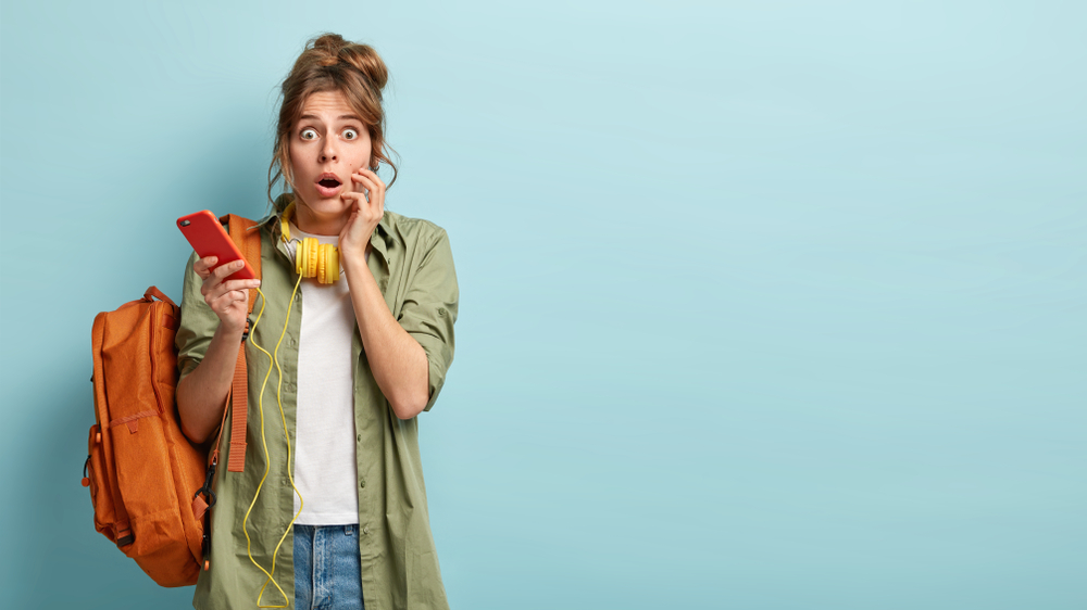 Woman wearing headphones with a surprised look on her face